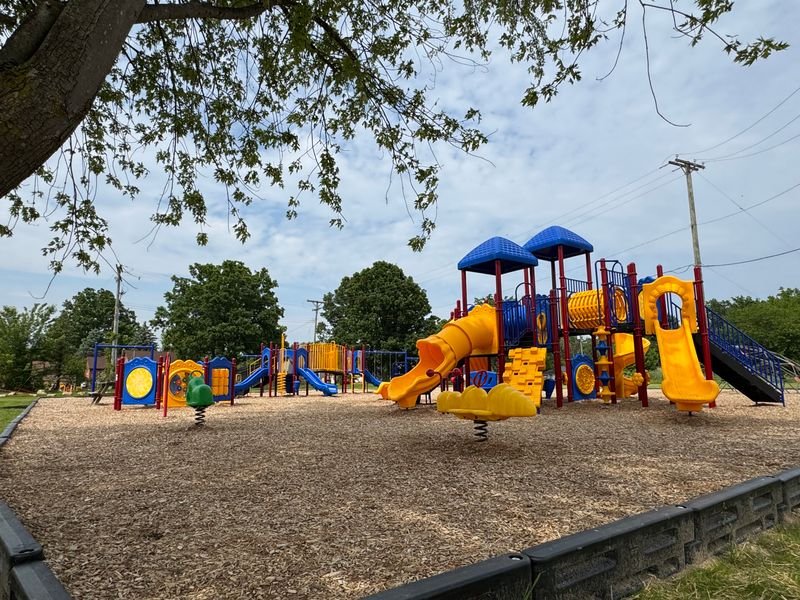 An expansive playground with commercial-grade equipment. There are two sections for kids of all abilities.
